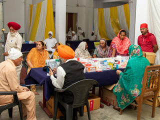 2026-free-medical-camp-bakhshish-international-charitable-society-nussi-jalandhar-03 Physician consulting patients and prescribing medicine at Gurdwara Bakhshish Dham free medical camp 2026
